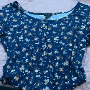 A blue T-shirt with three buttons at the top